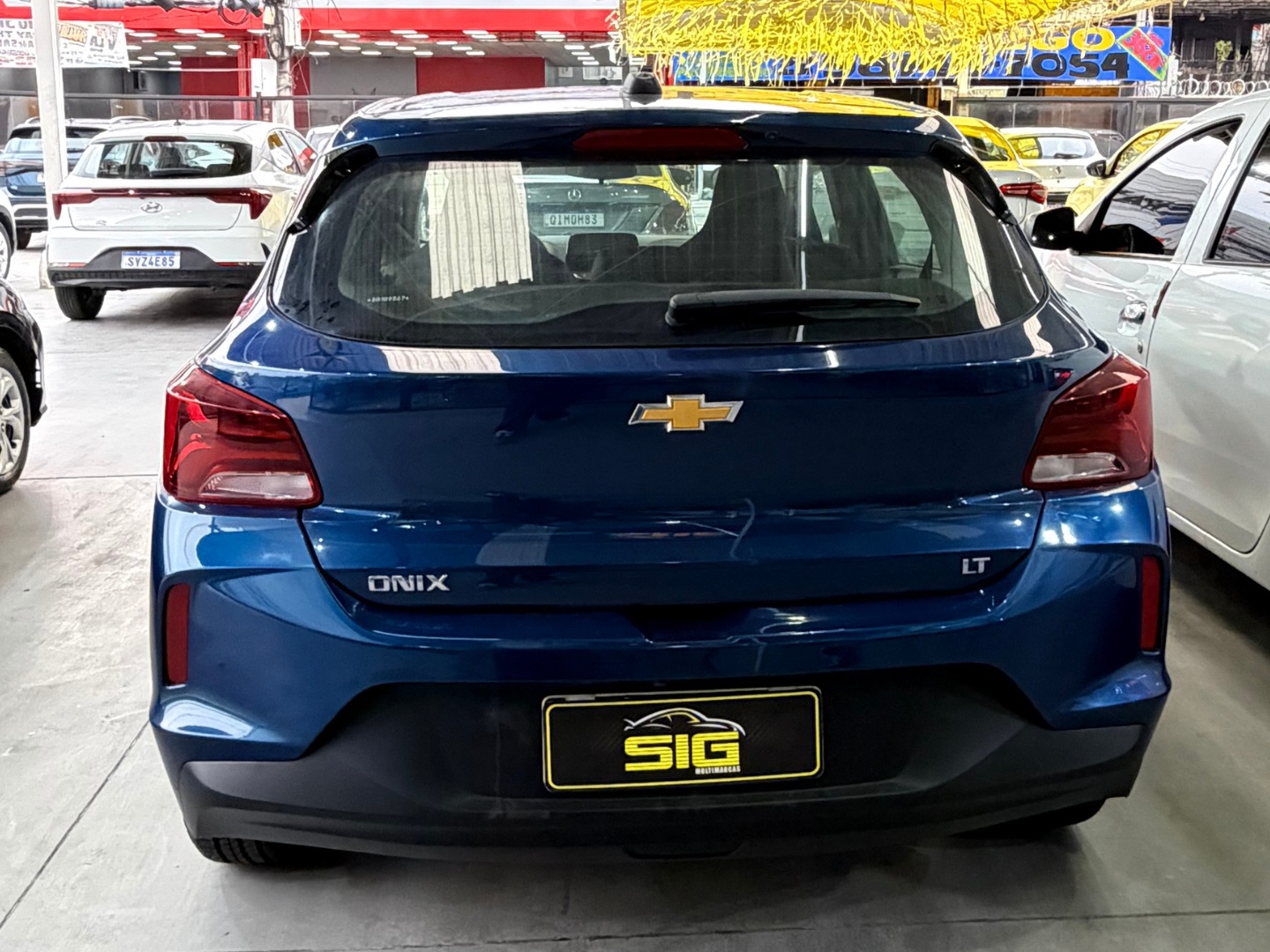 CHEVROLET ONIX 1.0 FLEX LT MANUAL 2025 Azul seminovo à venda em Duque de Caxias - Miniatura Traseira - SIG Multimarcas